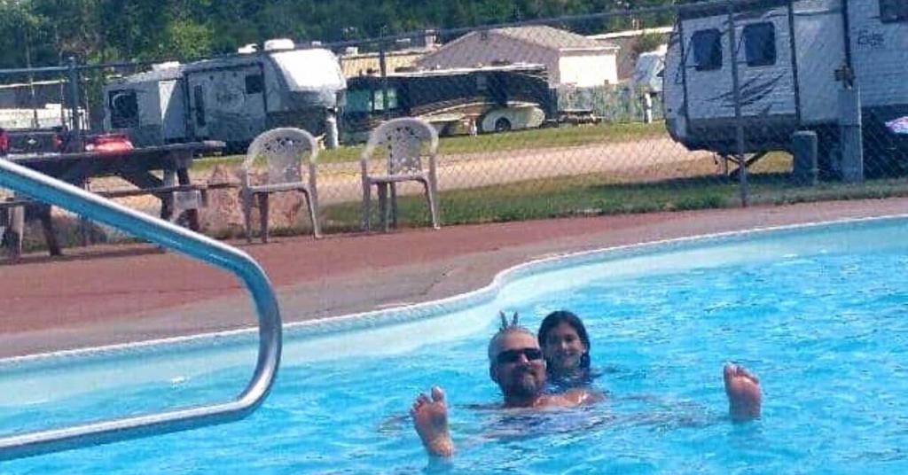 people swimming in a pool at a campground