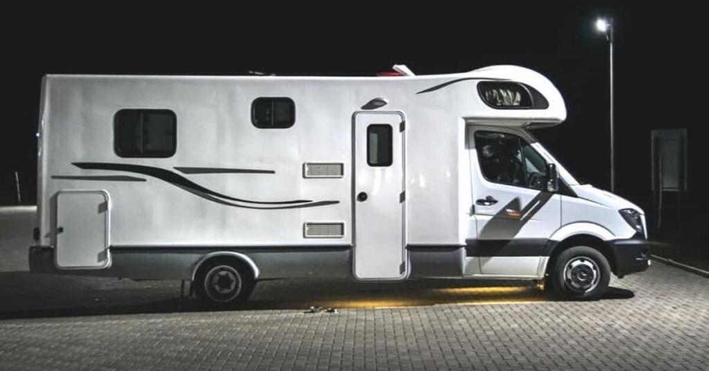 motorhome in a parking lot at night