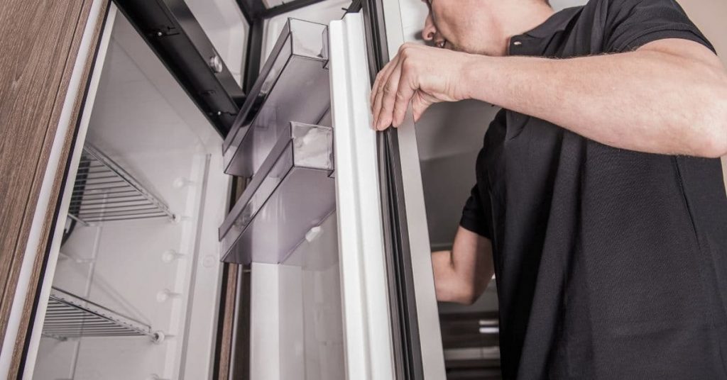 man working on rv refrigerator