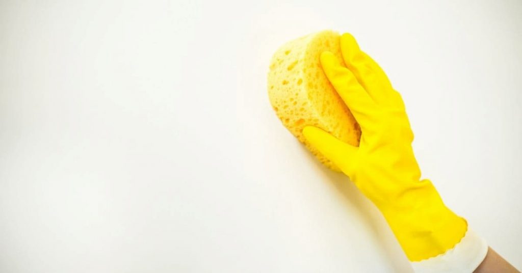 wiping wall with a sponge