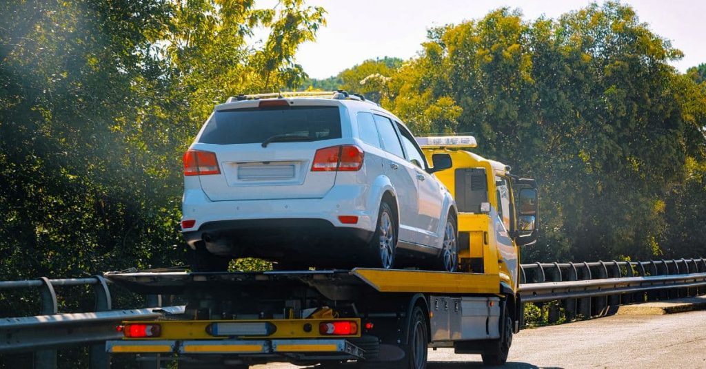 car on a flatbed tow truck
